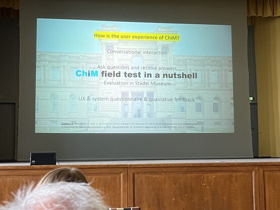 Projection screen displaying a presentation slide about user experience with "ChiM field test in a nutshell" as the main title. The audience is partially visible with the back of a person's head in the foreground.